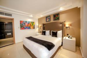 a hotel room with a large bed and a large mirror at Victoria Crown Plaza Hotel in Lagos