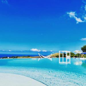 a view of a beach with an island in the background at Casamediterranea in Sperlonga