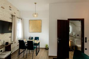a dining room with a table and chairs at Deluxe Town Hall Square Flat in Historical Center 2 in Corfu