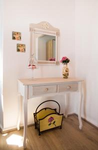 a white dressing table with a mirror and a basket at spongkalyA apartment I in Kalymnos