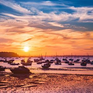 a group of boats sitting in the water at sunset at Quayside in Poole