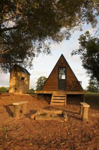 a small cabin with a bench in front of it at Riverside Retreat in Taunton