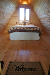 a bedroom with a bed in a attic with a window at Riverside Retreat in Taunton