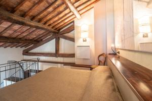 a room with a wooden floor and a large window at Hotel Della Fortezza in Sorano