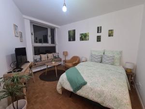 a bedroom with a bed and a living room at Vivez La forêt - Port de plaisance - Plage in Le Havre