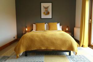 a bedroom with a bed with a yellow bedspread at Acarsaid B&B in Lybster