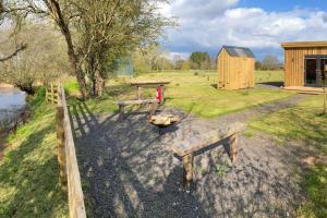 a park with benches and a fire hydrant and a building at Lakeside Lodge in Taunton