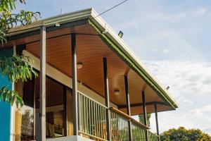 a large building with a balcony on the side of it at Corcovado Green Cabin in Drake