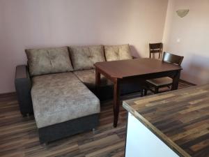 a living room with a couch and a table at Guest Rooms Mihaylovi in Pavel Banya