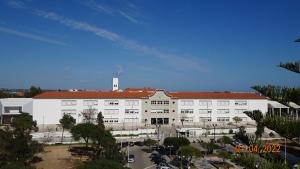 a large white building with a red roof at BELVEDERE SUITE in Faro