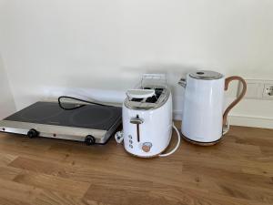 two toasters and a toaster sitting on a counter at Ferienhaus Ferienwohnung Petermännchen in Westerburg