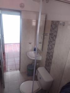 a bathroom with a toilet and a sink at Club Recreativo Las Guitarras in Florián