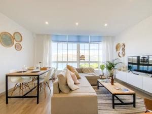 a living room with a couch and a table at Apartamento Fufú by ALÔGA in Corcubión