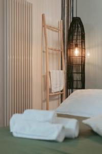 a room with a bed and a chair and a table at Laguna Suite B&B in Chioggia