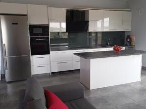 a kitchen with white cabinets and a white counter top at summer-house in Metókhi