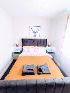 een slaapkamer met een groot bed en 2 badjassen bij Crystal Suite 3 Free Private Parking in South Shields