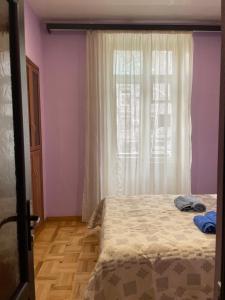 a bedroom with a bed and a window at Cozy Apartment on Republic Square in Yerevan