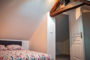 a bedroom with a bed and an open door at Vernon, Le Pacia in Vernon