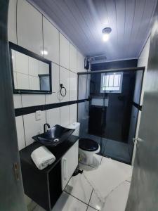 a bathroom with a sink and a toilet at ACONCHEGO DE CANELA/RS in Canela
