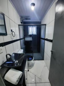 a small bathroom with a sink and a toilet at ACONCHEGO DE CANELA/RS in Canela