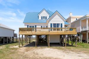 a house being constructed with a large wooden deck at Surf N' Turf in Dauphin Island