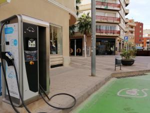 a pay phone is being charged on a city street at lo flamenc @Amposta in Amposta