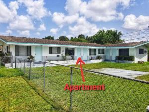 a fence in front of a house with a red arrow at Ultra Glam Apartment 6 Miles From Hard Rock Stadium and Casino in Hollywood