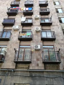 a tall brick building with balconies and windows at Dublex Apartment in Yerevan komitas D1 in Yerevan