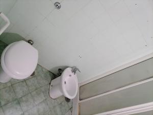 a white bathroom with a toilet and a sink at Sahary in Naples +26 photos