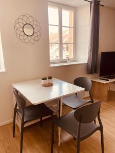 a dining room with a table and two chairs at Le bastion in Pontarlier