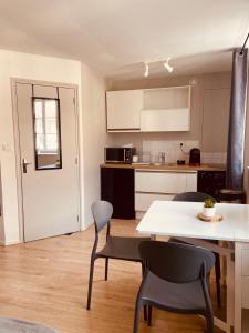 a kitchen and dining room with a table and chairs at Le bastion in Pontarlier