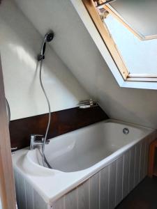 a bath tub in a bathroom under a roof at Chambrecosy salle de bain privée in Quimper +12 photos