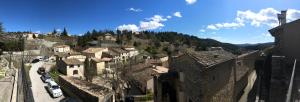 an aerial view of a village with buildings and cars at MAISON DE VILLAGE AUREL in Aurel +17 photos