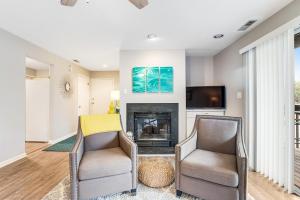 a living room with two chairs and a fireplace at Eagles Landing I --- 260 Sea Eagle Dr Unit 7 in Rehoboth Beach