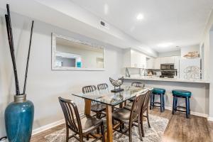 a dining room with a glass table and chairs at Eagles Landing I --- 260 Sea Eagle Dr Unit 7 in Rehoboth Beach