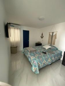 a bedroom with a bed and a television in it at Salinas villa in La Libertad