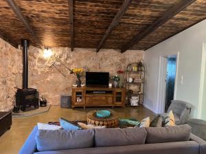 a living room with a couch and a table at Maunder Cottage Aldinga Township in Aldinga