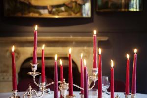 a group of lit red candles on a table at Old Parsonage Hotel in Oxford