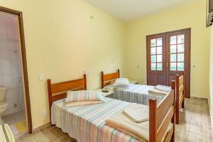 En eller flere senge i et værelse på Pousada do Marquinhos