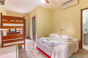 En eller flere senge i et værelse på Pousada do Marquinhos