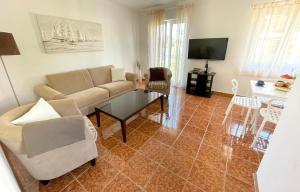 a living room with a couch and a table at Apartman Rosi in Dramalj