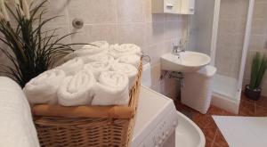 a bathroom with towels in a basket next to a sink at Apartman Rosi in Dramalj +17 photos