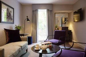 a living room with a couch and a table at Old Parsonage Hotel in Oxford