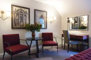 a waiting room with chairs and a table and a desk at Old Parsonage Hotel in Oxford