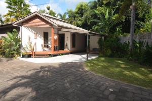 a small house with a patio and a yard at Do Not Book in Nelly Bay
