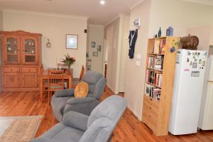 a living room with two chairs and a refrigerator at Do Not Book in Nelly Bay