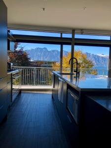 a kitchen with a view of the mountains at Remarkable Escape in Queenstown