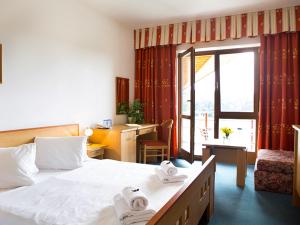 A bed or beds in a room at K-Triumf Resort