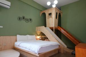 a bedroom with a bed and a staircase in a room at Provence Homestay in Magong
