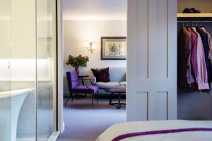a hotel room with a bedroom and a living room at Old Parsonage Hotel in Oxford